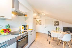 a kitchen and dining room with a table and chairs at Apartment Egon in Malinska
