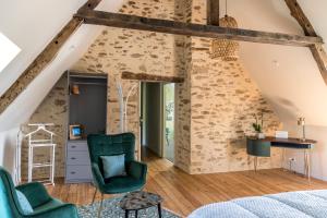 a bedroom in an attic with green chairs and a bed at Le Prieuré Saint-Malo de Dinan in Dinan +34 photos
