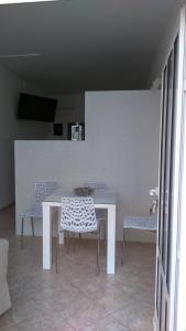 a white table and chairs in a room at Swiss holiday 4 in Split