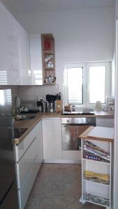 a kitchen with white cabinets and a counter top at Swiss holiday 4 in Split