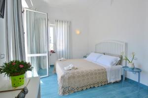 Postel nebo postele na pokoji v ubytování Casa OIKIA Anacapri
