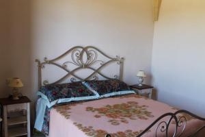 A bed or beds in a room at Masseria Cricelli