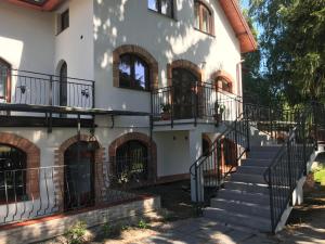 a building with stairs and balconies on it at Gościniec Twoje Mazury nad jeziorem Śniardwy tuż obok plaży in Nowe Guty