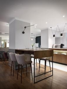 a kitchen with a dining table and chairs at B60 Hotel in Moscow