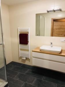 a bathroom with a sink and a mirror at Pernerhof in Mariapfarr +26 photos