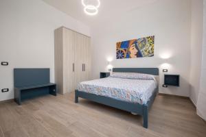 En eller flere senge i et værelse på Trinacria Apartments