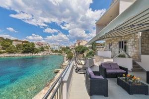 a balcony with chairs and a view of the water at Villa Antonija 1607 in Ražanj