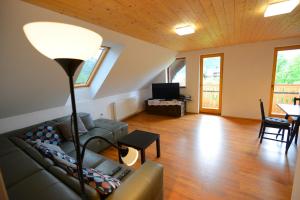 a living room with a couch and a table at Apartmaji Pekovec Bohinj in Bohinj