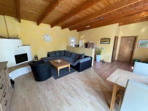 a living room with a couch and a table at Gemütlicher Bungalow am Meer in Pepelow in Pepelow