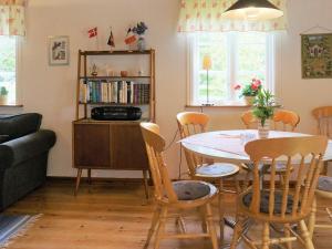 a living room with a table and chairs at 6 person holiday home in ÅSARP-By Traum in Åsarp