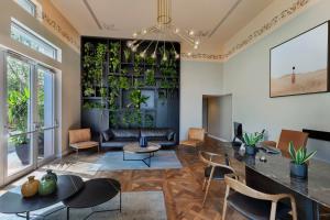 a living room with a plant wall at Bachar House By 7Minds in Tel Aviv