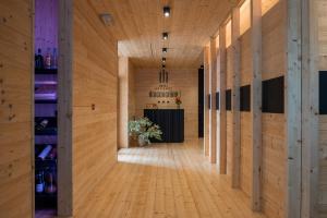 a hallway with wood paneling and a bar in the distance at Draconerium Hotel in Dronero