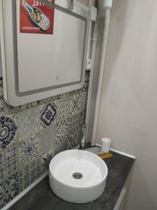 a bathroom with a white sink on a counter at Le Central Vittel 206 in Vittel