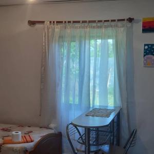 a room with a table and a window with a table at Antonio's rooms (2 single beds) in Krujë