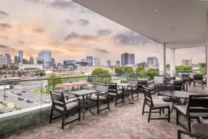 a patio with tables and chairs and a view of the city at TownePlace Suites by Marriott Nashville Midtown in Nashville