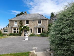 a large brick house with a large driveway at Fairwater Head in Axminster