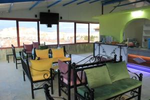 a group of chairs and tables in a room with mountains at loopy lodge hotel in Ürgüp