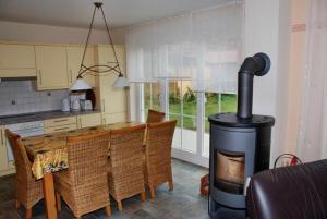 a kitchen with a wood stove in the middle of a room at "Tau Hus" im "Roden Hus" in Timmendorf