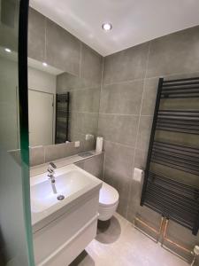 Un baño con lavabo blanco y inodoro. en Modernes Apartment Duisburg Homberg, en Duisburg