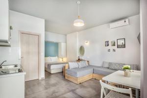 a living room with a couch and a table at Armyra studios in Pefkochori +41 photos
