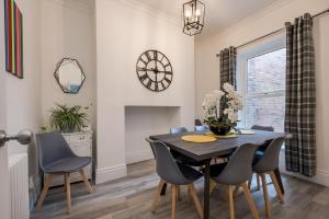 a dining room with a table and chairs at Central Belfast Apartments: Georgian House in Belfast