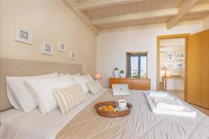 a bedroom with a bed with a tray of oranges on it at Sunny Penthouse,Modern Amenities+Aegean View in Rhodes Town