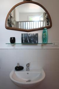 a bathroom with a sink and a mirror at Il Trullo del Cadetto in Francavilla Fontana