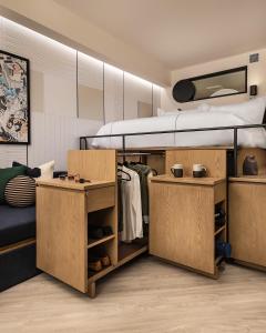 a bedroom with a bed and a dresser at The Catbird Hotel in RINO in Denver