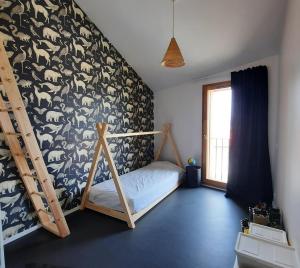 a bedroom with a bed and a wall covered in animals at élégante villa neuve d'architecte in Dallet
