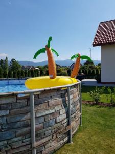 a yellow inflatable trampoline with two fruit on it at ŚNIEŻKA HOUSE in Mysłakowice