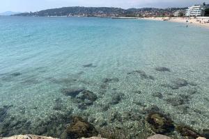 a view of a beach with crystal clear water at Juan les Pins Joli T2 parking inclus! in Antibes +5 photos