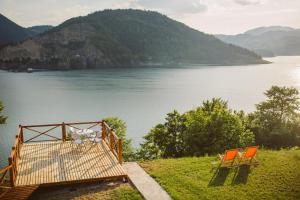 two orange chairs sitting next to a body of water at Zoranovi konaci in Jevtići