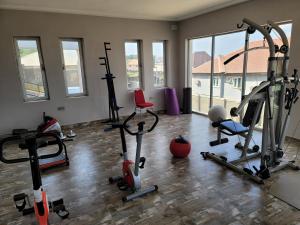 a gym with a bunch of exercise equipment in a room at Camas Hotel & Suite Asero Abeokuta in Abeokuta