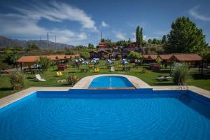 a swimming pool in front of a resort at Posada Cacheuta in Las Compuertas