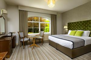 a hotel room with a bed and a desk and a window at Brook Lodge Boutique Hotel in Killarney