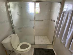 a small bathroom with a shower and a toilet at Private Cubicle - Single Bed - Mixed Shared Dorm - MIAMI AIRPORT in Miami