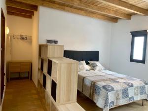 a bedroom with a bed with a wooden bed frame at Casa Nepal in Playa Blanca