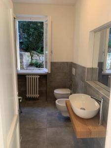 a bathroom with two toilets and a sink and a window at Alta Marina in Marciana Marina