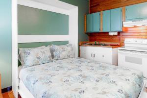 a small bedroom with a bed and a kitchen at Carbo House Eleven in Tybee Island