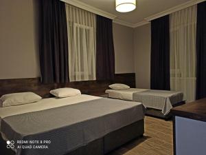 a hotel room with two beds and a window at Merve Apart Hotel in Alanya