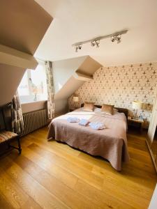 a bedroom with a large bed and a large window at Gasthof Maerlant in Damme