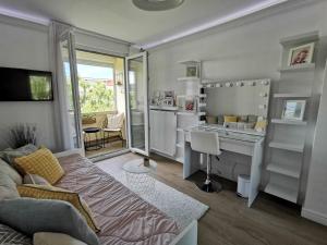 a living room with a couch and a desk at Lux Apartment with Sauna & Balcony in Banja Luka