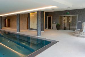 a swimming pool in the middle of a building at Wellness Apartmány Panorama in Luhačovice