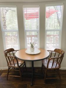 a table with two chairs and a table with a plant on it at Lazy Z Resort in Twain Harte