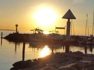 a group of boats docked at a dock at sunset at Robby1 in Kaltenhof