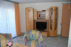 a living room with a couch and a tv at Langenwerder in Kaltenhof