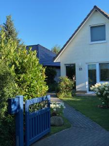 a blue fence in front of a house at Fenster in Kaltenhof +12 photos