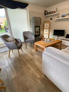 a living room with a couch and a table at Fenster in Kaltenhof