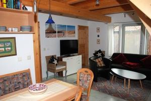 a living room with a couch and a table at Hexenhäuschen in Kaltenhof