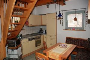 a small kitchen with a table and a table and chairs at Hexenhäuschen in Kaltenhof +14 photos